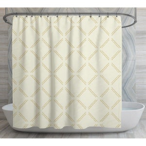 May include: A white shower curtain with a geometric pattern of small gold dots forming diamond shapes.