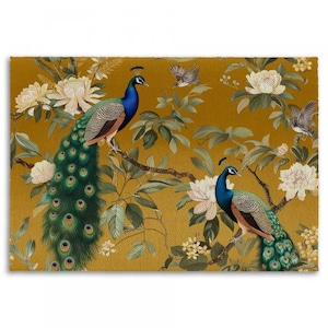 May include: Two peacocks with blue and green plumage are perched on branches of a tree with white flowers. The background is a yellow-gold color.