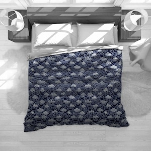 May include: A navy blue duvet cover with a white wave pattern. The duvet cover is made of soft, comfortable fabric and features a repeating pattern of stylized waves.