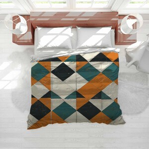 May include: A bed with white pillows and a geometric patterned duvet cover. The duvet cover features a diamond pattern in teal, orange, black, and white. The bed is set against a white wall with windows and lamps on either side.