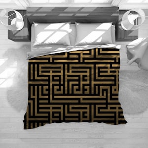 May include: A black and gold geometric patterned duvet cover with a maze-like design.