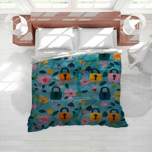 May include: A teal duvet cover with a floral and lock pattern. The design features colorful flowers, green leaves, and locks in orange, yellow, pink, and blue. The bedding is on a wooden bed frame with white pillows.
