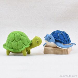 A green felt turtle and a a blue sea turtle. Their sewing patterns & instructions are available as a pattern bundle for instant download from muumade.etsy.com.
