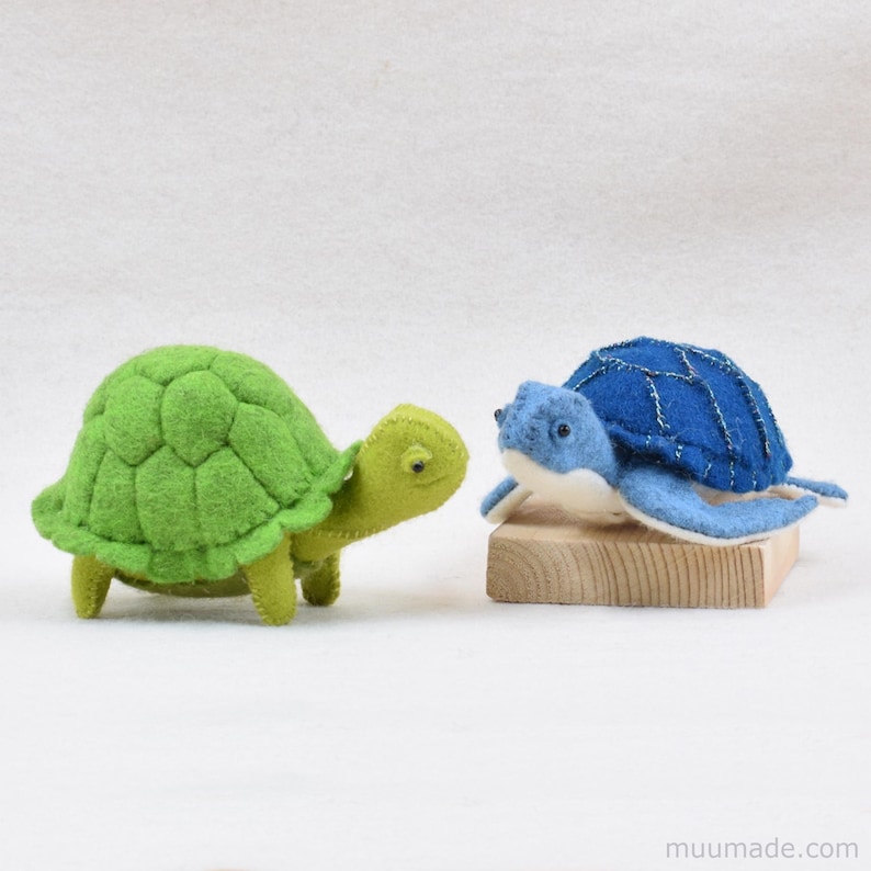 A green felt turtle and a a blue sea turtle. Their sewing patterns & instructions are available as a pattern bundle for instant download from muumade.etsy.com.