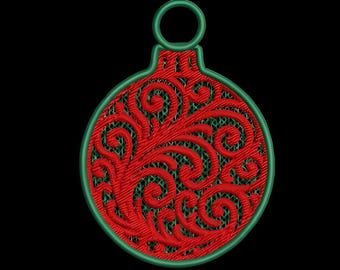 May include: A red and green Christmas ornament with a detailed, swirling design. The ornament has a green outline and a loop at the top for hanging. The background is black.