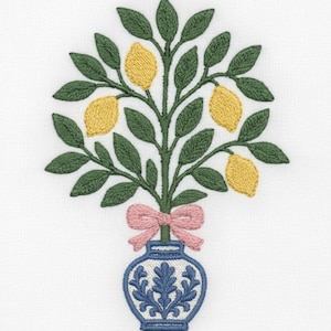 May include: Embroidered design of a lemon tree in a blue and white vase with a pink bow. The tree has green leaves and yellow lemons. The vase has a blue floral pattern. The design is on a white background.