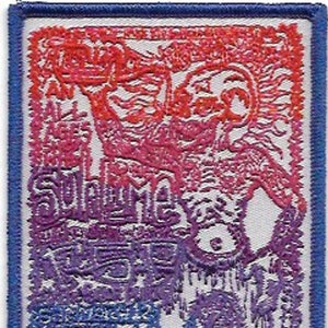 May include: A white patch with a blue border featuring a colorful graphic design with the text "Red Hot Chili Peppers" and "Sublime" in a purple and pink gradient. The design is reminiscent of a concert poster.