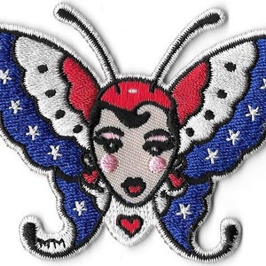 May include: Embroidered iron-on patch featuring a butterfly with red, white, and blue wings. The butterfly has a human face with black hair and a red heart on its chest.