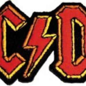 May include: A red and yellow embroidered patch with the word "AC/DC" in a bold, stylized font.
