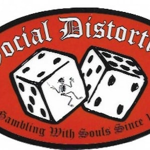 May include: A red oval sticker with the text "Social Distortion" in a black gothic font. The sticker features two white dice with black dots and a skeleton figure in the center. The text "Gambling With Souls Since 1979" is printed below the dice.