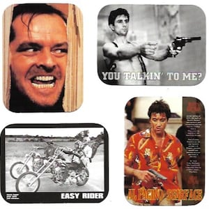 May include: Four square coasters featuring iconic movie characters and scenes. The top left coaster shows Jack Nicholson as Jack Torrance from "The Shining" with the text "Here's Johnny!" The top right coaster shows Robert De Niro as Travis Bickle from "Taxi Driver" with the text "You talkin' to me?" The bottom left coaster shows a black and white image of a motorcycle from the movie "Easy Rider" with the text "Easy Rider." The bottom right coaster shows Al Pacino as Tony Montana from "Scarface" with the text "Al Pacino Scarface."