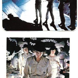 May include: Two different images of the film poster for "A Clockwork Orange". The first image shows four figures in white clothing standing in a dark, futuristic setting. The second image shows a close-up of one of the figures from the first image, with the text "Clockwork Orange" at the bottom.