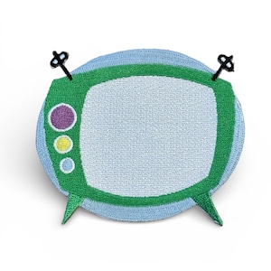 May include: Embroidered patch featuring a retro television design. The patch has a green border and a light blue background. The TV screen is white, with a purple, yellow, and blue button cluster. Two black antenna are attached.