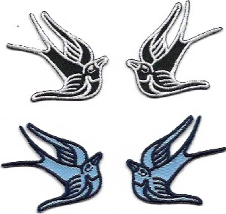 May include: Two pairs of iron-on patches featuring a stylized swallow design. One pair is black with white outlines, and the other pair is blue with black outlines.