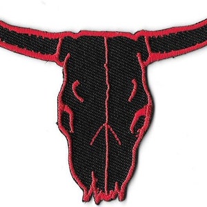 May include: Black and red embroidered patch of a bull skull with horns.