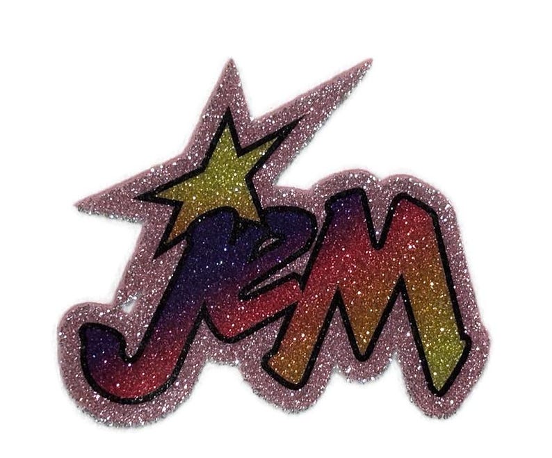 May include: A pink, glittery iron-on patch with the word "Jem" in a rainbow gradient and a yellow star.