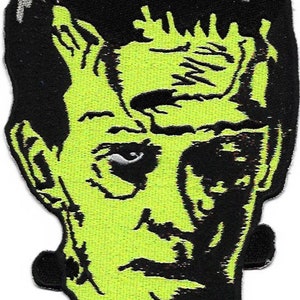 May include: Green and black embroidered patch of Frankenstein's monster's face.