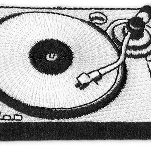 May include: A black and white embroidered patch depicting a vintage record player with a needle and record on the turntable.