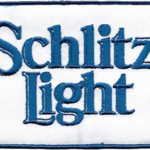 May include: A white embroidered patch with blue lettering that reads "Schlitz Light".