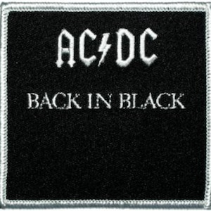May include: Black and white embroidered patch with the text "AC/DC" and "BACK IN BLACK" in a bold font.