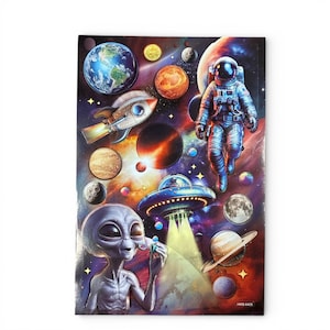 May include: A colorful space-themed notebook featuring planets, a rocket, an astronaut, an alien, and a UFO. The background is a vibrant mix of reds, blues, and purples, with stars and other celestial bodies. The notebook has the text "HMS-6405" at the bottom.
