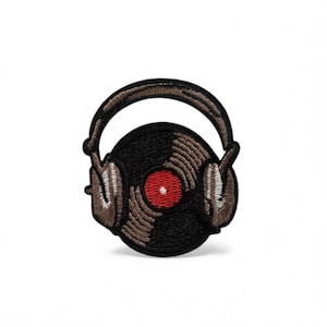 May include: Embroidered patch depicting a black vinyl record with a red centre, and brown headphones. The patch has a detailed design, suitable for adding to clothing or accessories. The patch is on a white background.