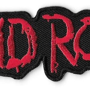 May include: Red embroidered patch with the word "SKID ROW" in a dripping, stylized font on a black background.