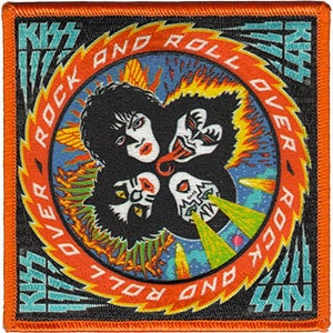 May include: Square patch featuring the band KISS. The design includes four stylized faces, the words "ROCK AND ROLL OVER" in a circular pattern, and the band's name. The patch has an orange border and a black background.