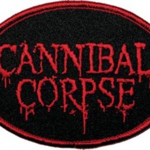 May include: Black and red oval patch with the text "Cannibal Corpse" in a dripping blood font.