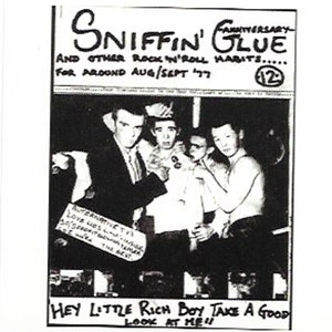 May include: Black and white photo of a group of four young men. The photo is from a magazine called "Sniffin' Glue" and is dated August/September 1977. The text "Hey Little Rich Boy Take A Good Look At Me" is written at the bottom of the photo.