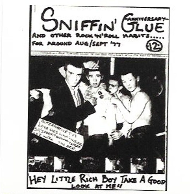 May include: Black and white photo of a group of four young men. The photo is from a magazine called "Sniffin' Glue" and is dated August/September 1977. The text "Hey Little Rich Boy Take A Good Look At Me" is written at the bottom of the photo.