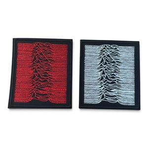 May include: Two rectangular embroidered patches with black borders. One patch features a red stitched graphic of a pulsar wave pattern on a black background, while the other patch displays the same wave pattern in white thread on a black background.