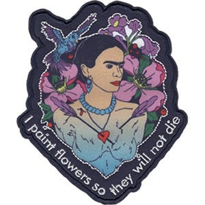 May include: A colorful embroidered patch featuring Frida Kahlo with flowers and birds. The text reads "I paint flowers so they will not die."