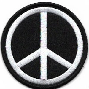 May include: A white peace sign embroidered on a black fabric patch.