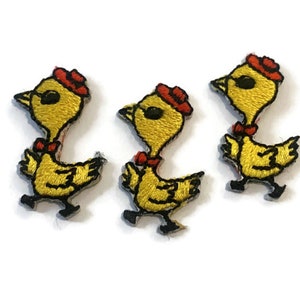 Puede incluir: Tres parches bordados amarillos para planchar de pollitos con sombreros rojos y pajaritas.