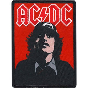 Pode incluir: Uma imagem em preto e branco de um músico usando um chapéu preto e uma jaqueta preta. O fundo é vermelho com a palavra "AC/DC" em branco.