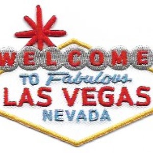 Op de afbeelding: Een geborduurde patch met de woorden "Welcome to Fabulous Las Vegas Nevada" in een ruitvorm met een rode ster bovenop.