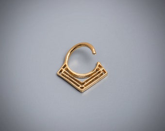 May include: Gold-toned geometric nose ring with a circular hoop and a diamond-shaped design.
