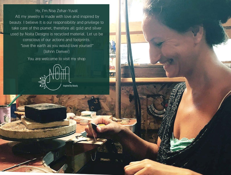 May include: A woman working on jewelry in her workshop. She is using a small tool to shape a piece of metal. The text on the wall reads "Hy, I'm Noa Zohar-Yuval. All my jewelry is made with love and inspired by beauty. I believe It is our responsibility and privilege to take care of this planet, therefore all gold and silver used by Noita Designs is recycled material. Let us be conscious of our actions and footprints. 'love the earth as you would love yourself' (Johnn Denver) You are welcome to visit my shop Noita Inspired by Beauty."
