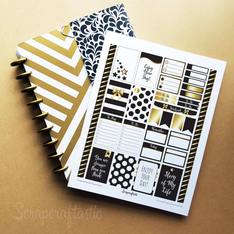 May include: A gold and white striped planner with gold disc binding, a black and white patterned cover, and a sheet of black, white, and gold planner stickers. The stickers include text that says "Enjoy Your Day!" and "Story of My Life."