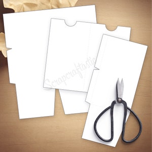 May include: A printable template for a paper box with a flap. The template is printed on white paper and includes dotted lines for cutting and folding. A pair of scissors is included in the image.