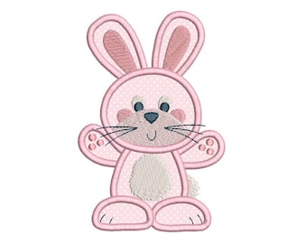May include: A pink bunny with white polka dots, a white belly, and a black nose. The bunny has a smiling mouth and blue eyes.