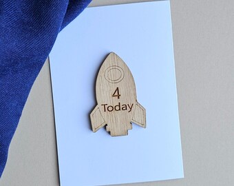 May include: Wooden rocket-shaped birthday card with the number 4 and the word "Today" engraved on it.