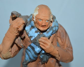 Figurine / elderly man / carrying wood / clay / brown / blue / 8" x 3" x3" / clay figurine / man / grandpa / figurine man / grandpa figurine
