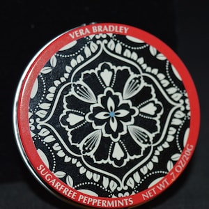 Tiny tin /  black / red / white / design /  2" diameter x .75" / Good condition / round / tin / small tin / pill box / mints / Vera Bradley