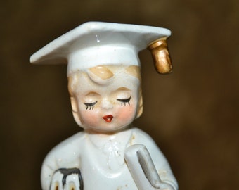 Graduate figurine / girl / dressed in white / cap and gown / gold trim / made in Japan / 1950s / 4" x 1.25" / Japan / figurine