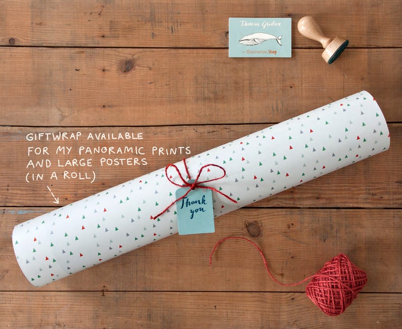May include: A roll of white wrapping paper with a pattern of small green and red triangles. The paper is tied with twine and a small blue tag that says "Thank you".