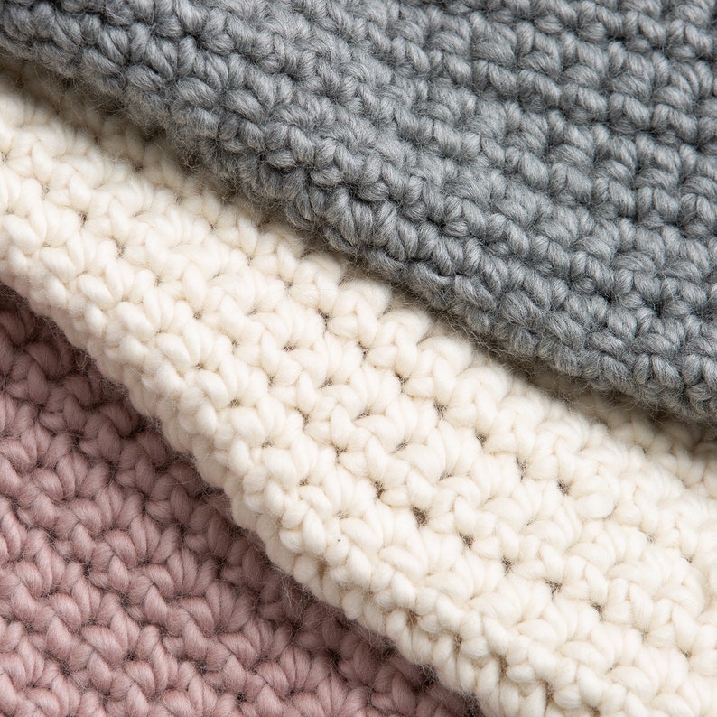 May include: Three different colored crocheted fabric swatches. The top swatch is gray, the middle swatch is white, and the bottom swatch is pink.