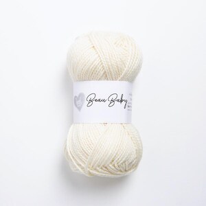 May include: A skein of white yarn labeled "Beau Baby" with a heart logo.
