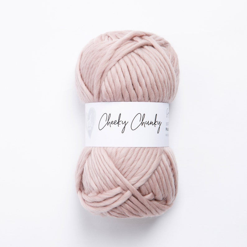 May include: A ball of pale pink yarn labeled "Cheeky Chunky" on a white background.
